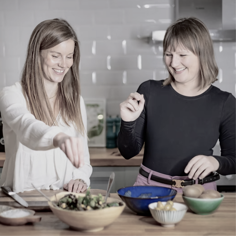 Image of dietitians Catherine Nash and Rosie Hogg preparing food in a kitchen